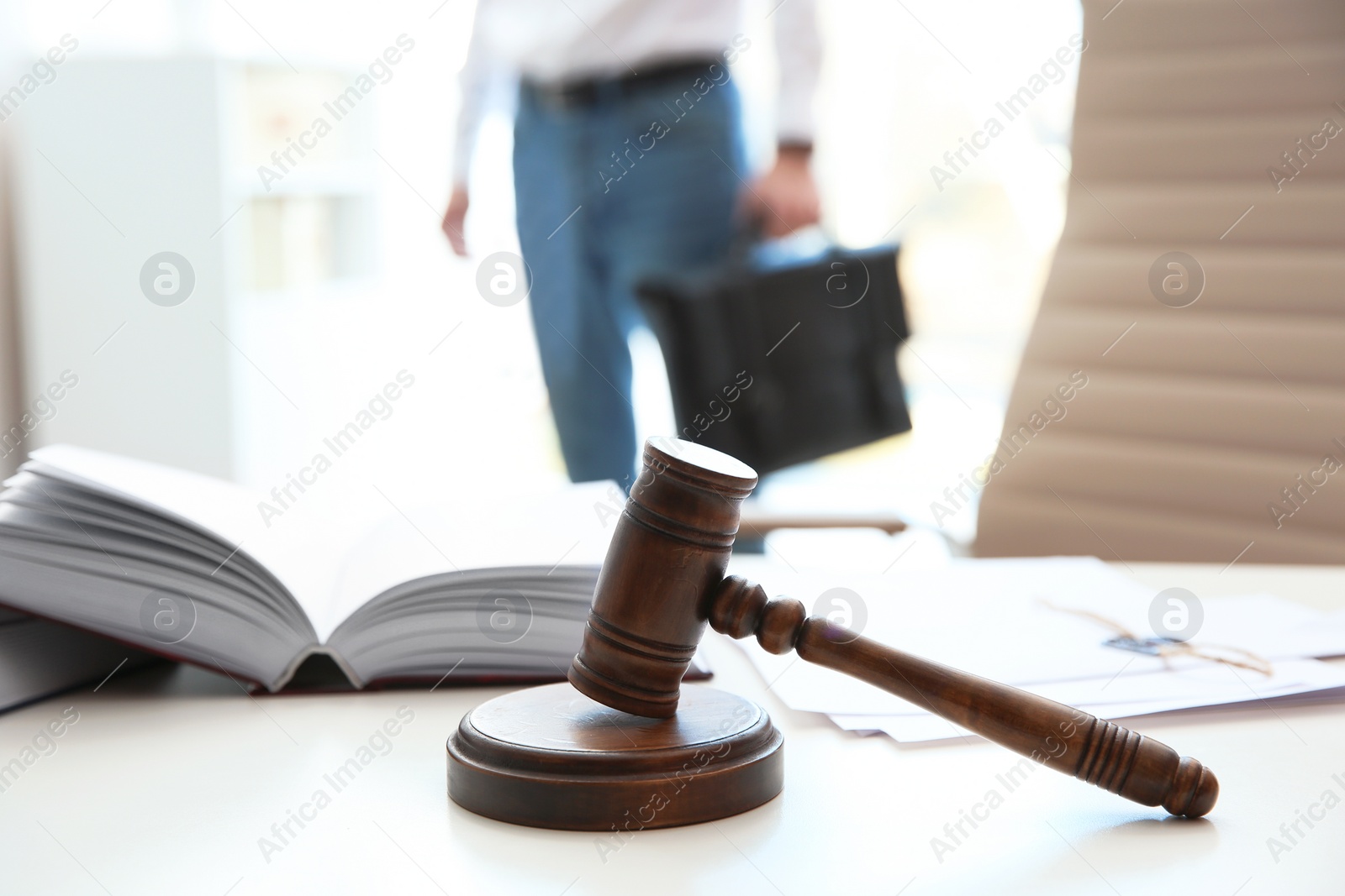 Photo of Judge's gavel, law books and papers on table in notary office