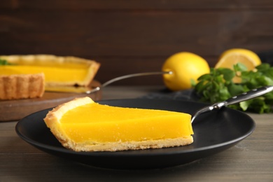 Photo of Delicious homemade lemon pie on wooden table