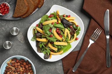 Photo of Delicious fresh carrot salad served on grey table, flat lay