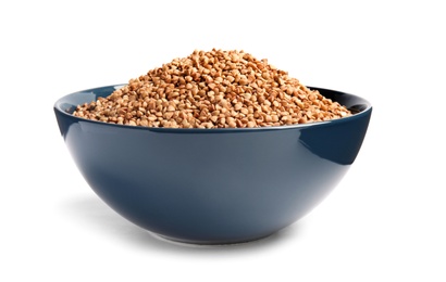 Bowl with uncooked buckwheat on white background