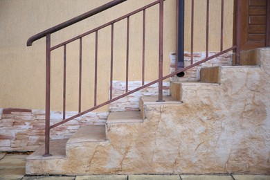 Photo of View of beautiful stairs with metal handrail near house outdoors