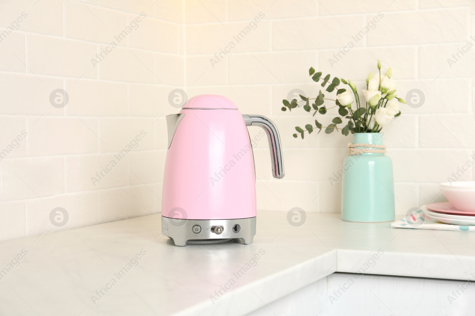 Photo of Modern electric kettle on counter in kitchen