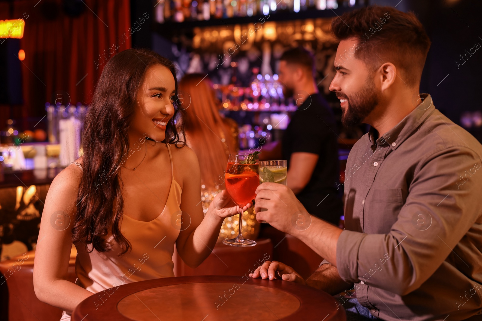 Photo of Lovely couple with fresh cocktails in bar
