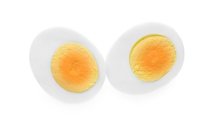 Halves of fresh hard boiled egg on white background, top view