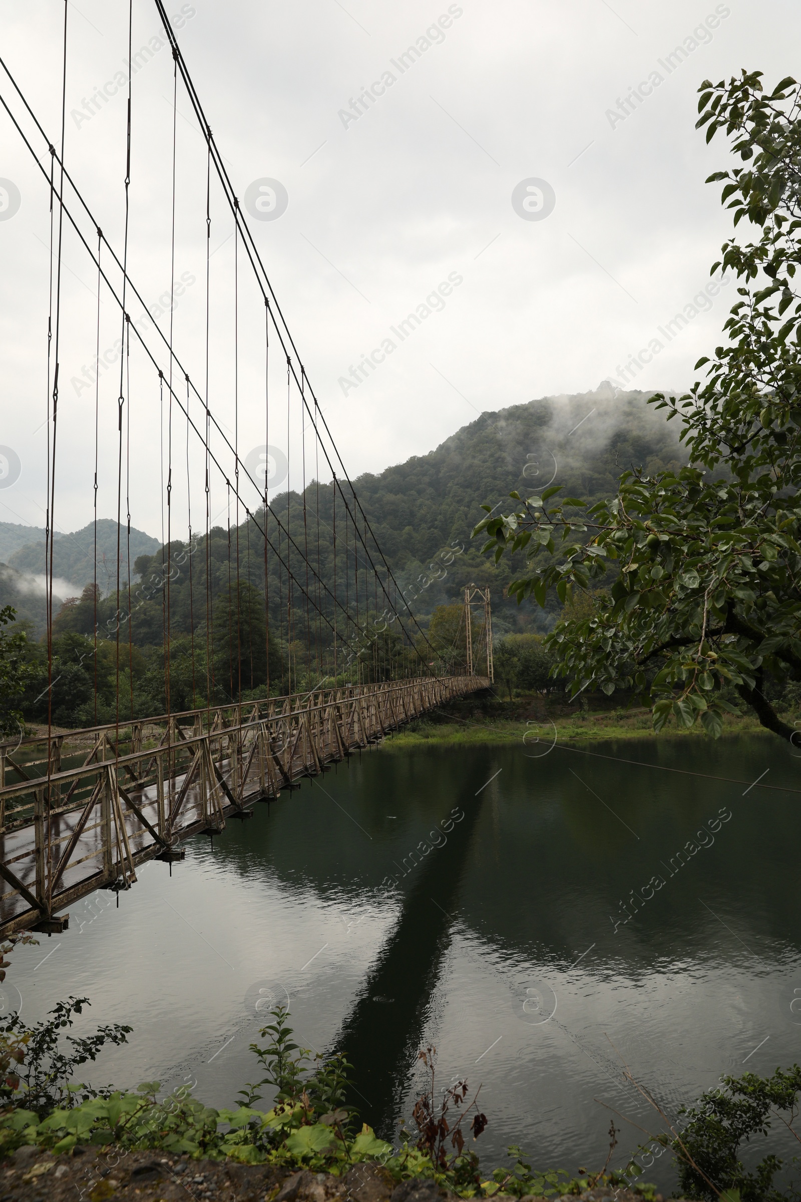 Photo of Beautiful view on rusty metal bridge over river in mountains