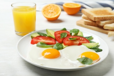Photo of Delicious breakfast with fried eggs served on table, closeup