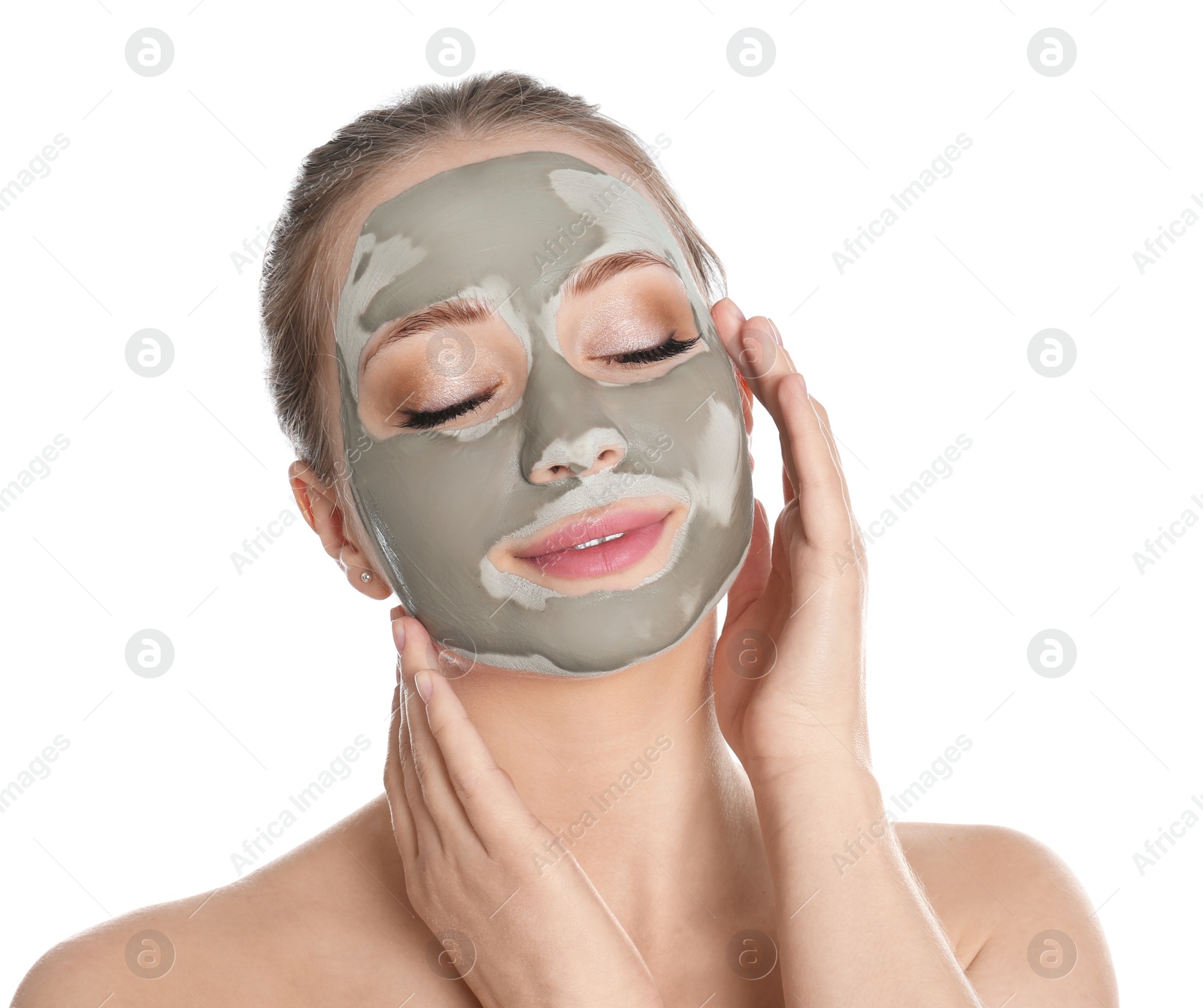 Photo of Beautiful woman with clay mask on her face against white background