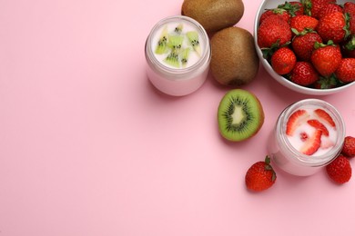 Photo of Tasty yogurt in glass jars and ingredients on pink background, flat lay. Space for text