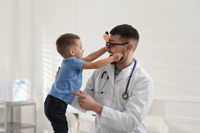 Photo of Pediatrician playing with little boy at hospital