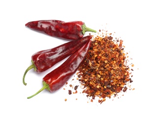 Dry chili peppers and powder on white background