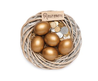 Photo of Golden eggs, coins and card with word Retirement in nest on white background, top view. Pension concept