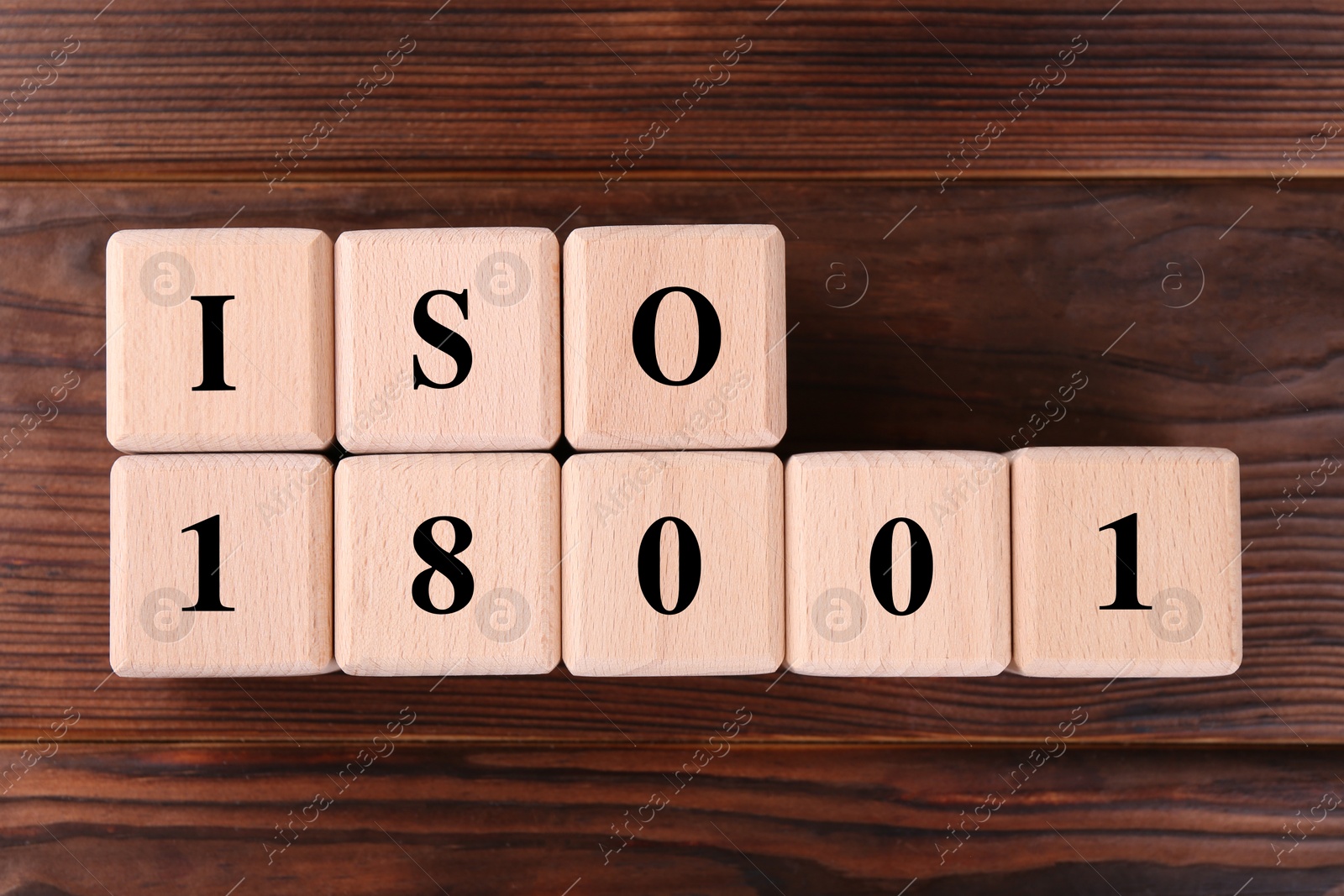 Photo of Cubes with abbreviation ISO and number 18001 on wooden table, flat lay