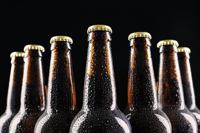 Photo of Many bottles of beer on dark background