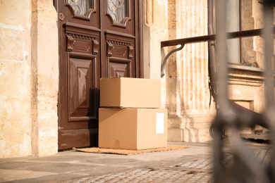 Delivered parcels on door mat near entrance