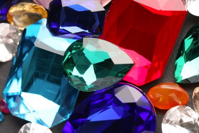 Photo of Different beautiful gemstones for jewelry on grey background, closeup