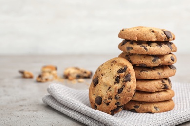 Stack of tasty chocolate cookies on gray table