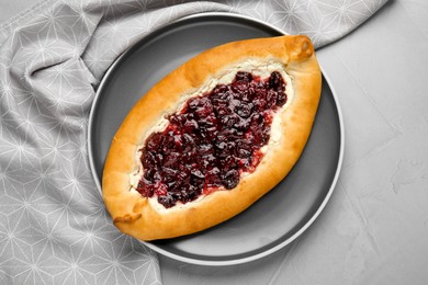 Delicious sweet cottage cheese pastry with cherry jam on grey table, top view