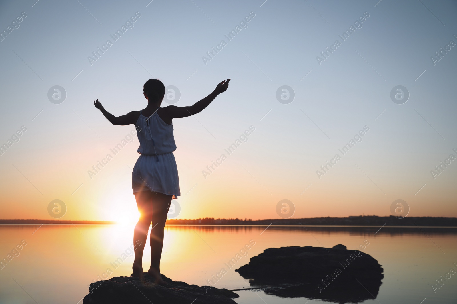Photo of Woman near river on sunset. Healing concept