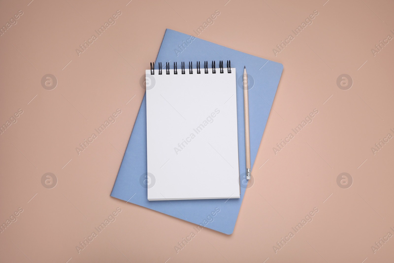 Photo of Blank notebook, planner and pencil on beige background, top view. Space for text