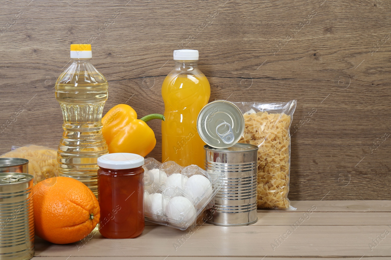 Photo of Many different donation food on wooden table