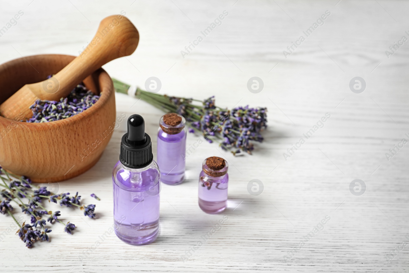 Photo of Composition with natural cosmetic products and lavender flowers on white wooden background. Space for text