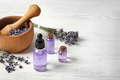 Photo of Composition with natural cosmetic products and lavender flowers on white wooden background. Space for text