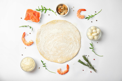 Photo of Flat lay composition with dough and fresh ingredients for seafood pizza on white background