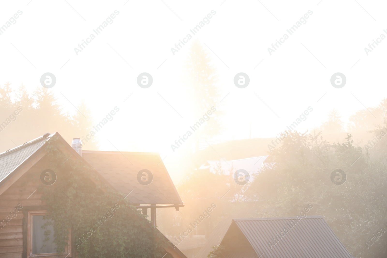 Photo of Beautiful view of sunrise over wooden houses