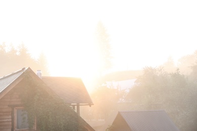 Photo of Beautiful view of sunrise over wooden houses