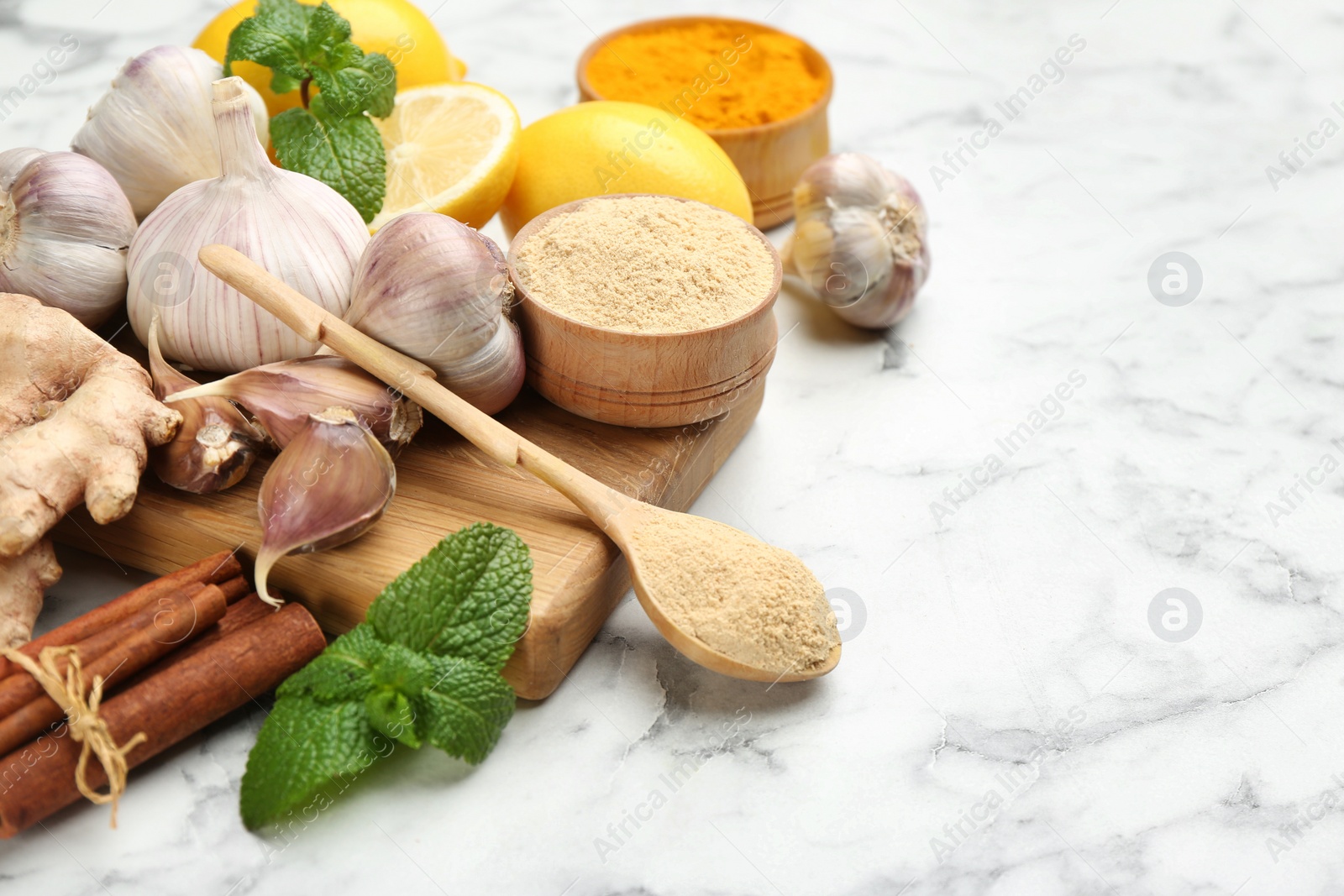 Photo of Different fresh products on white marble table, space for text. Natural antibiotics