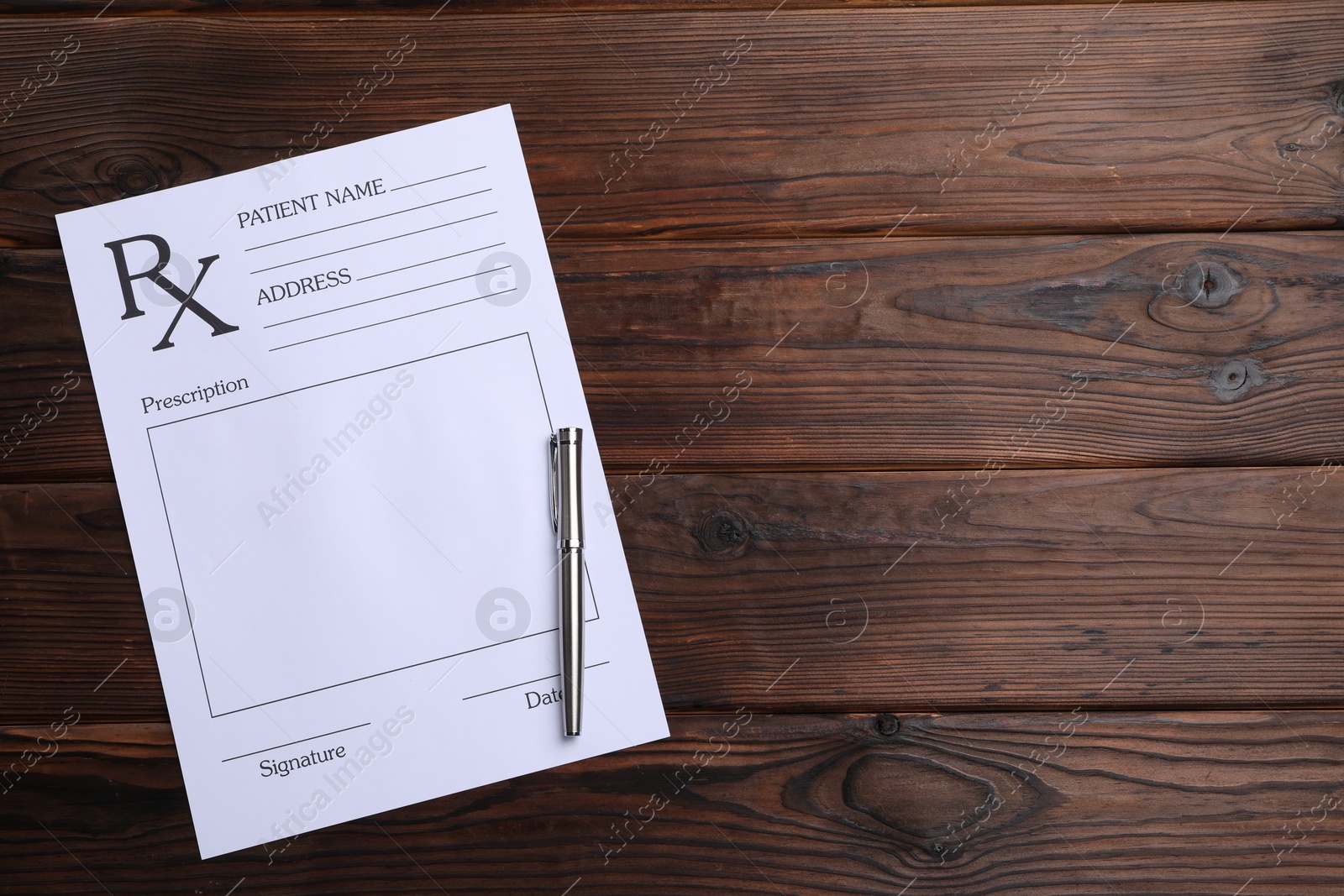 Photo of Medical prescription form with empty fields and pen on wooden table, top view. Space for text