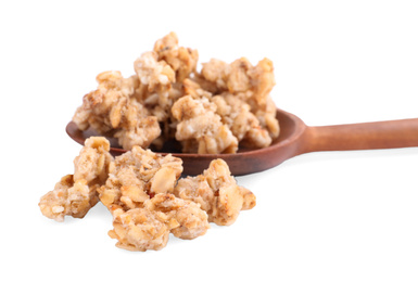 Tasty crispy granola and wooden spoon on white background