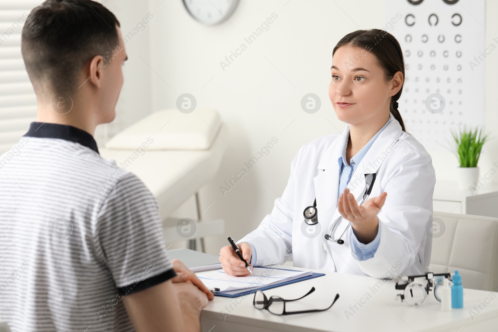 Photo of Vision testing. Young man having appointment with ophthalmologist in clinic