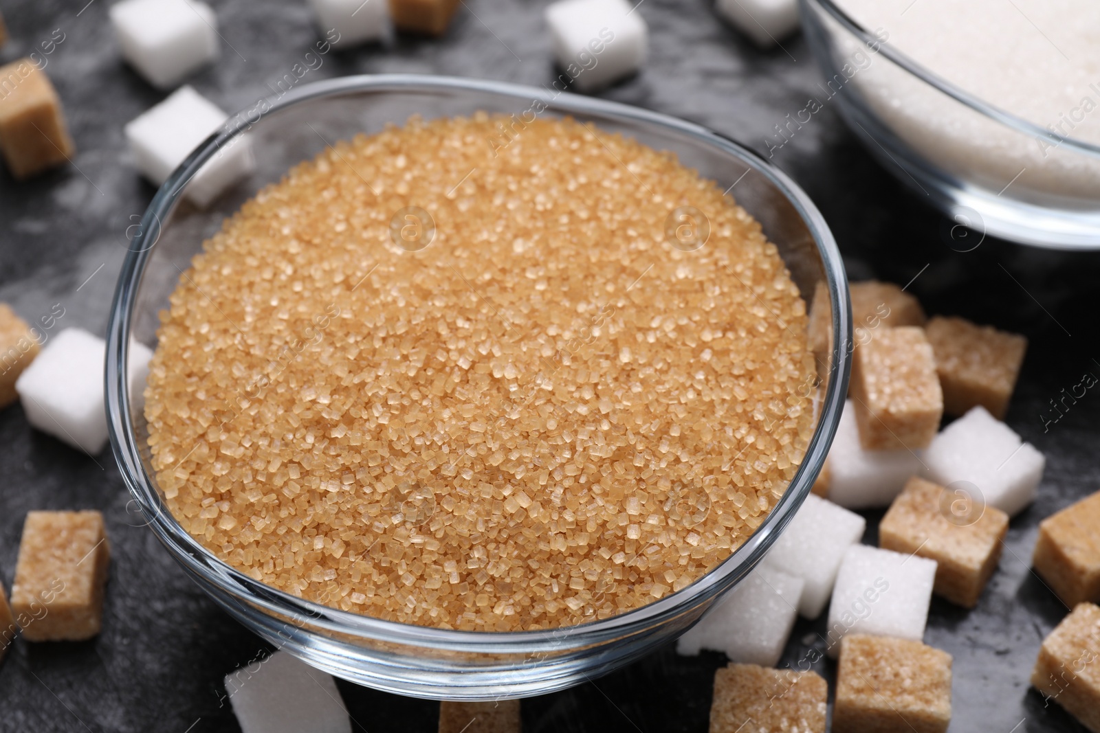 Photo of Brown sugar in bowl on table, closeup