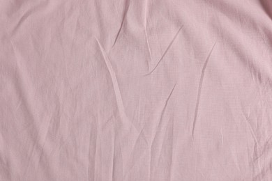 Crumpled pink fabric as background, top view