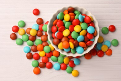 Photo of Tasty colorful candies on white wooden table, flat lay