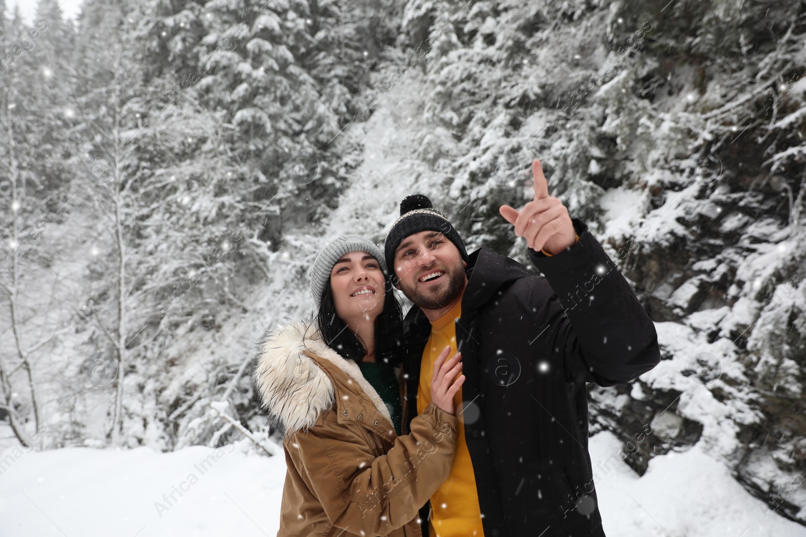 Photo of Lovely couple outdoors on snowy day. Winter vacation