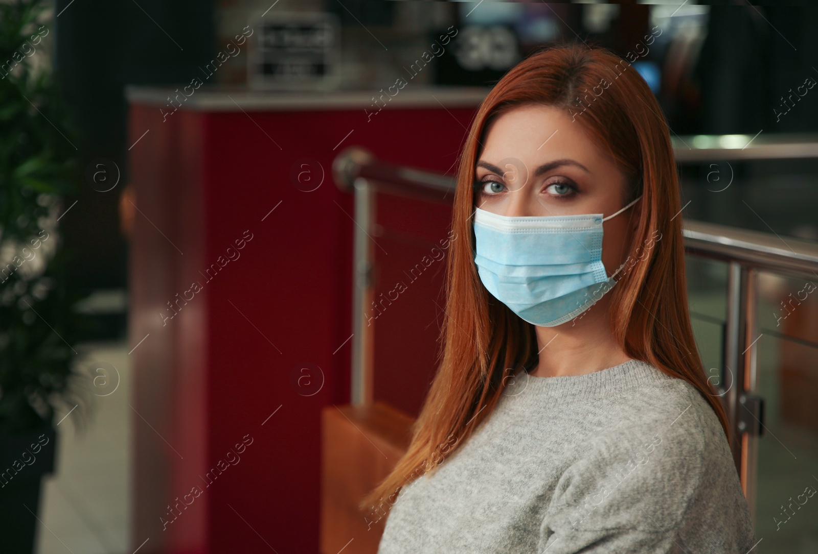 Photo of Woman with medical mask indoors. Virus protection