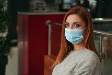 Woman with medical mask indoors. Virus protection