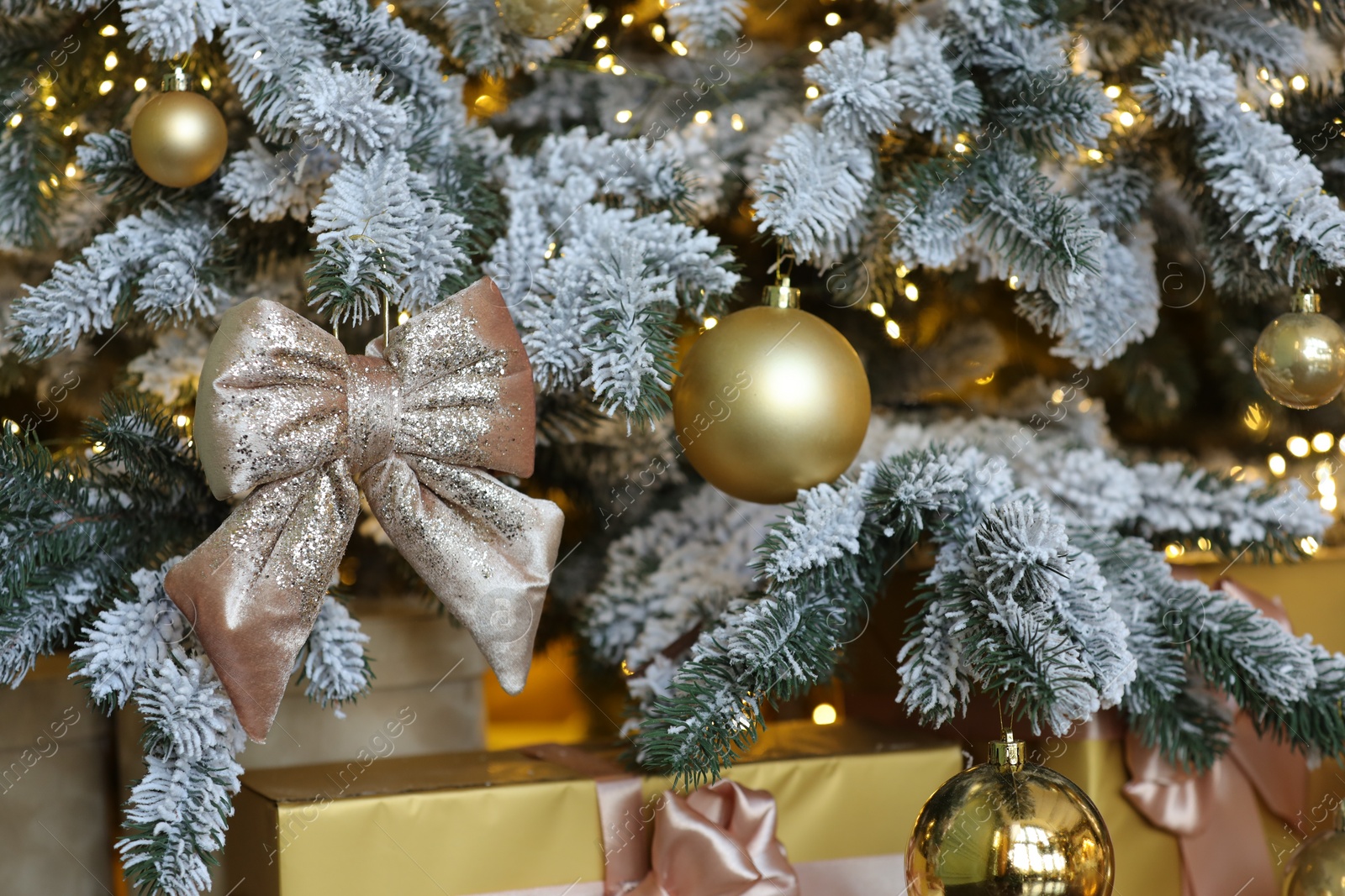 Photo of Many gift boxes under decorated Christmas tree at home, closeup