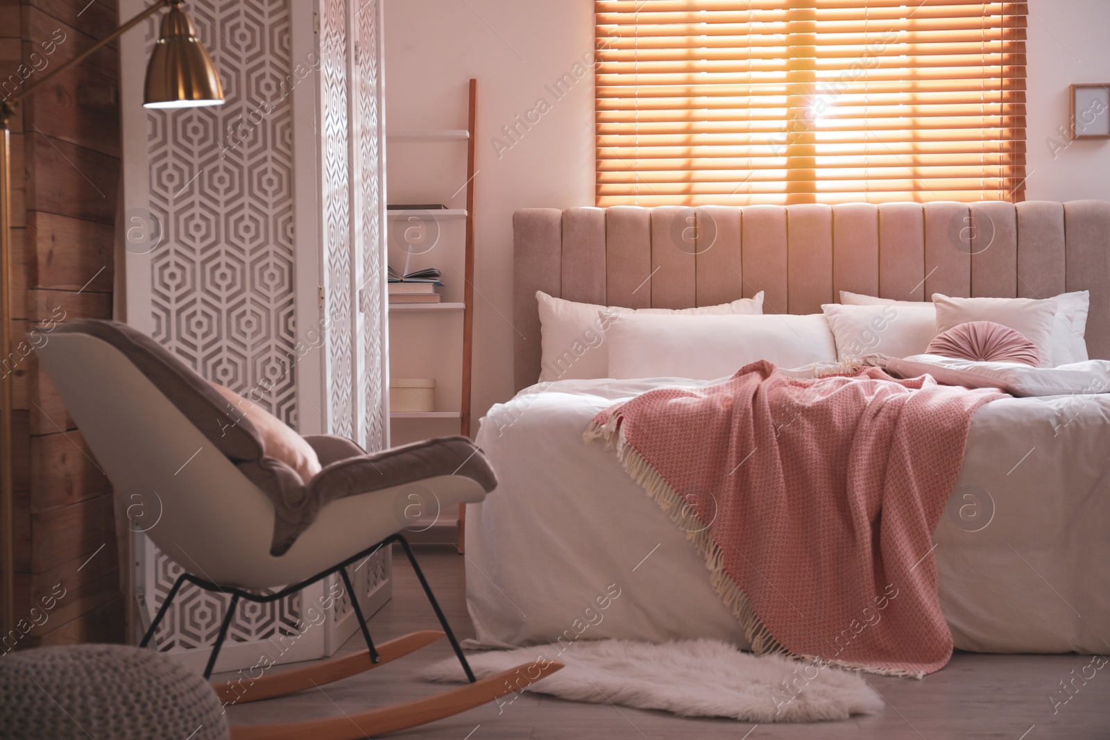 Photo of Cozy bed with soft linens in light room