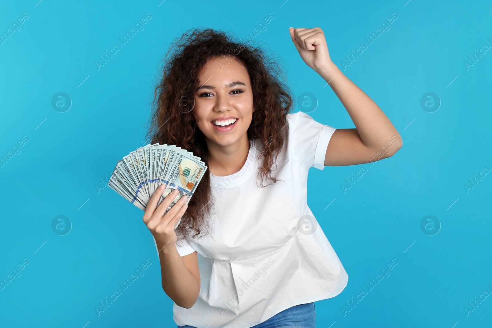 Photo of Young African-American woman with money on color background