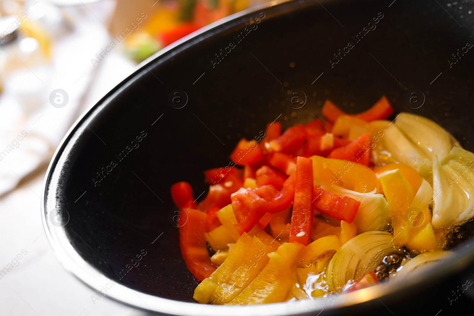 Photo of Cooking fresh vegetables in frying pan, closeup