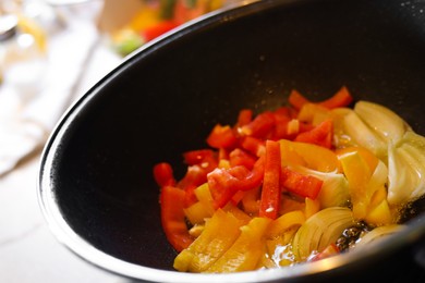 Photo of Cooking fresh vegetables in frying pan, closeup