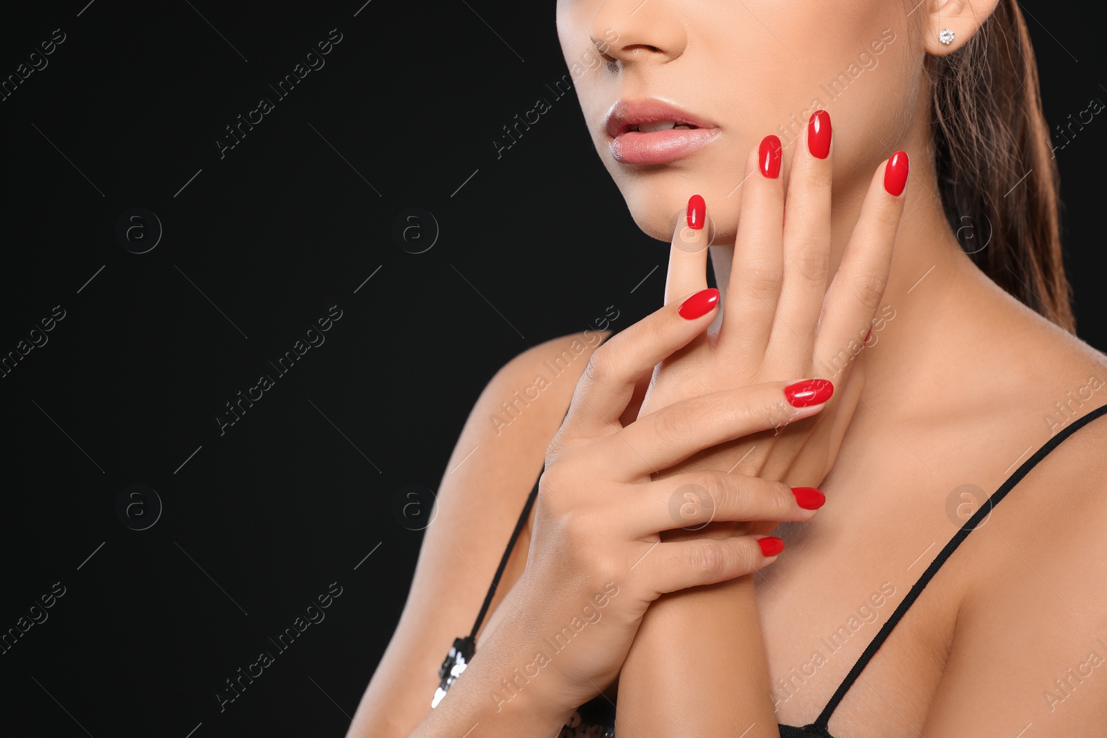 Photo of Closeup view of beautiful young woman with bright manicure on black background, space for text. Nail polish trends