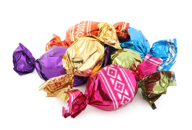 Pile of sweet candies in colorful wrappers on white background