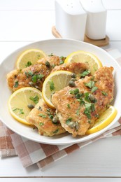 Photo of Delicious chicken piccata on white table, closeup