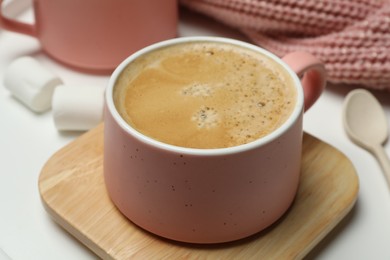 Photo of Cup of hot coffee on white table, closeup. Winter drink