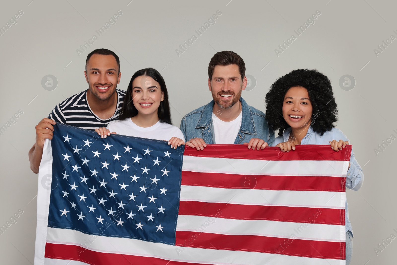 Photo of 4th of July - Independence Day of USA. Happy friends with American flag on grey background