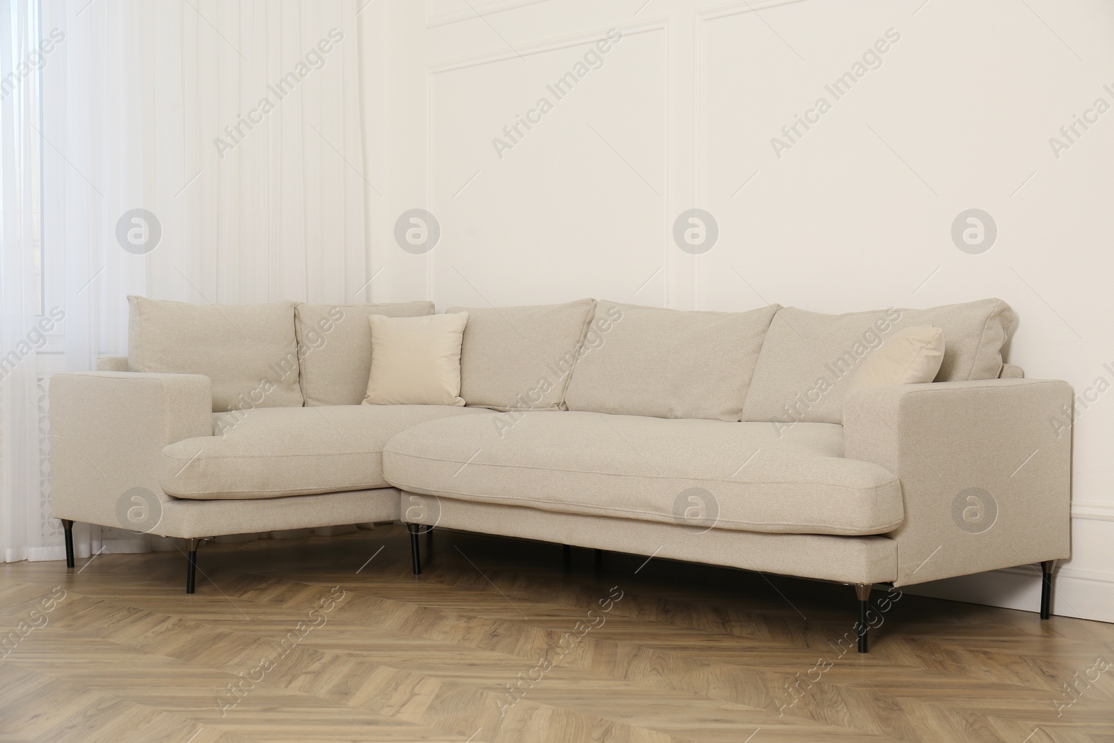 Photo of Comfortable sofa near white wall in living room